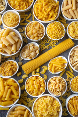 Composition with different tasty uncooked pasta - Italian pasta wallpaper, different types and shapes of pasta layout