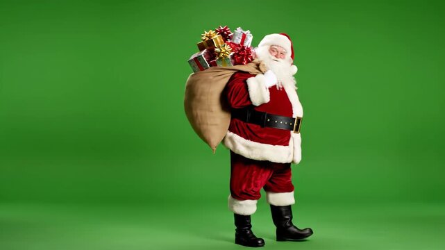 Santa Claus Walking with Sack of Presents on Green Screen - Santa Claus is shown walking on a green screen background, carrying a large sack filled with colorful wrapped presents.
