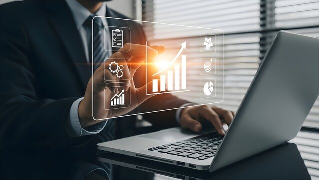 Businessman interacting with a futuristic holographic interface displaying data analytics and business growth charts above a laptop.