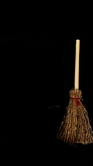Mini witch brooms on black background, occult props, mystical composition, esoteric tools for magic and rituals