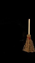 Mini witch brooms on black background, occult props, mystical composition, esoteric tools for magic and rituals