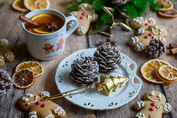 On the table there is New Year's tea 2026, coffee, gingerbread and pine cone cookies.