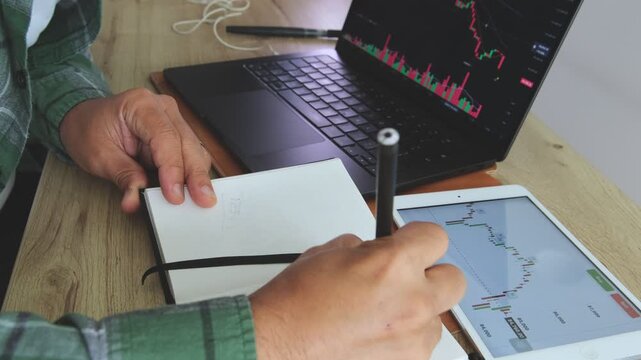 Investor analyzing stock market investment data at desk