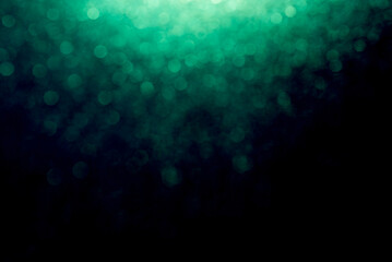 Abstract representation of defocused lights and particles in green