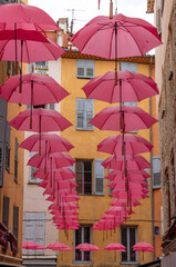 Streets of Grasse, a city known for its perfumery, decorated with pink umbrellas on the occasion of the annual international exhibition of roses - Expo Rose.