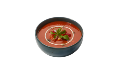 Bowl of tomato soup with garnish isolated on transparent background