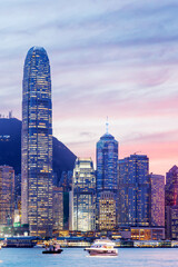 Hong Kong city skyline at sunset with glowing sky and skyscrapers