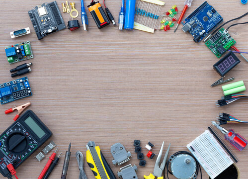 Top view of an electronics concept showing an Arduino UNO microcontroller with electronics configuration tools, with copy space for text
