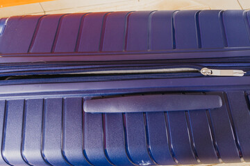 Close-up of the clasp on a blue suitcase