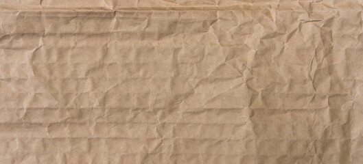 Obraz premium The texture of a banner made of crumpled kraft paper for packaging.