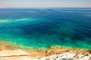 Obraz premium Rocky granodiorite coastline and clear turquoise water of the greek island of Serifos in the Cyclades