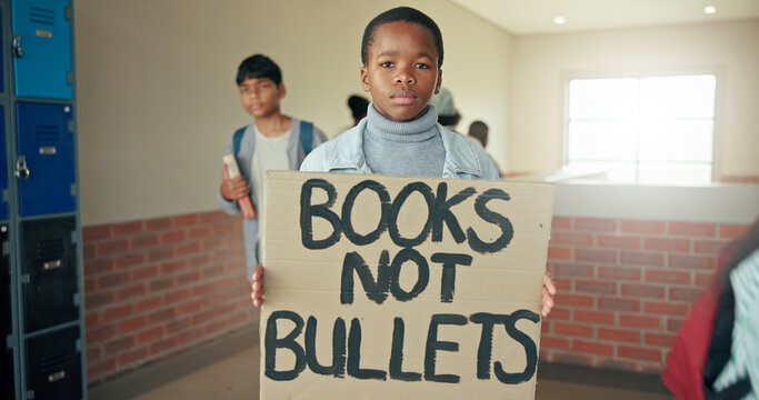 Portrait, education and boy with sign, protest and serious with placard, activism and voice. Learning, student and child in hallway, human rights mission or banner to promote equality or poster