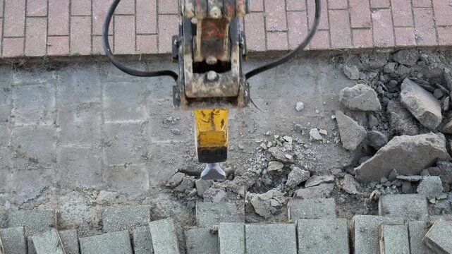 Jackhammer working on brick paver patio removal early morning project destroying hardscape destroying gray stone blocks
