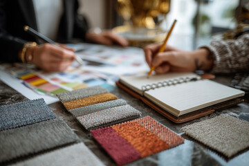 Designers work on project using fabric samples and mood boards in a creative studio space during the afternoon hours in a modern environment
