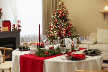 Festive table setting with Christmas decor indoors