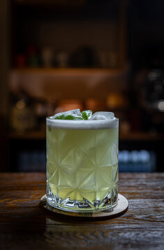 Basil cocktail on wooden bar