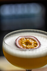 Cocktail with foam, and passion fruit garnish