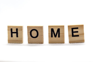 Wooden blocks with black letters spelling out "HOME" on a clean white background. A simple, minimalist, and very versatile image, ideal for themes of decoration, lifestyle, real estate, home, wellness