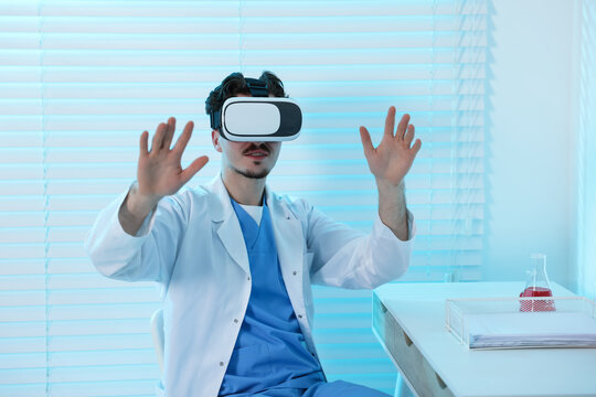 Modern technology. Doctor using virtual reality headset at desk in office