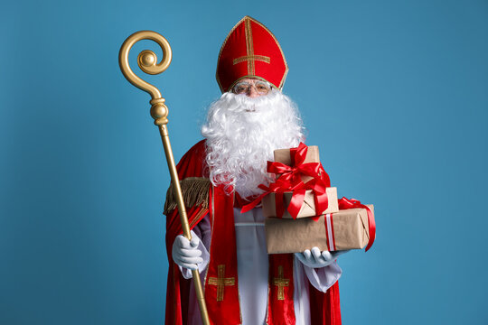 Saint Nicholas with gifts and crozier on blue background