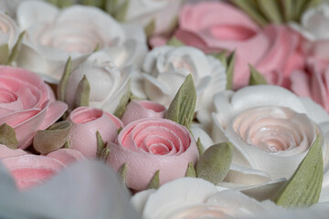 Beautiful arrangement of delicate pink and white roses crafted from soft materials, showcasing intricate details and textures, perfect for floral decoration and artistic inspiration
