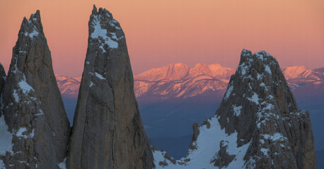 Jagged mountain peaks at sunset illuminated by warm light creating a scenic landscape