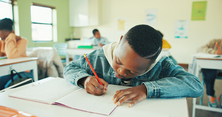 Classroom, child and writing notes in book for learning, maths lesson and practice sums for education. Calculation solution, kids or boy with problem solving in school, concentration or study numbers