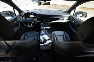 Interior of prestige modern car. Leather comfortable seats, dashboard and steering wheel. Electric car interior luxury. Cockpit with exclusive decoration. Touch panel climate control