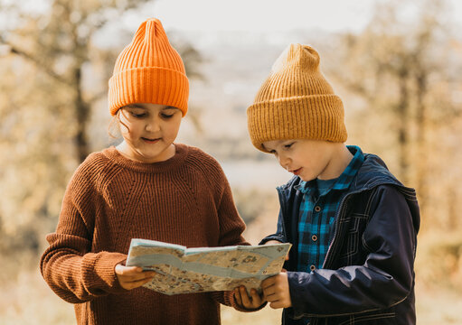 Children exploring in an autumn forest journey