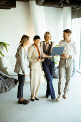 Fototapeta premium Team discussing project details in modern office space during afternoon meeting