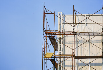 Construction scaffolding beside modern office building