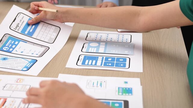 Panorama video of startup UX developer or company employee design user interface or UI prototype for mobile application or website software with software display on smartphone in office. Synergic