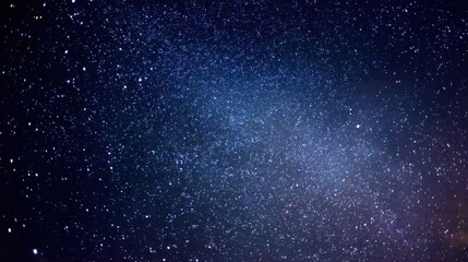 Fototapeta premium A breathtaking display of stars fills the night sky with specks of light. The vast backdrop of space creates a sense of wonder and tranquility in the dark evening.