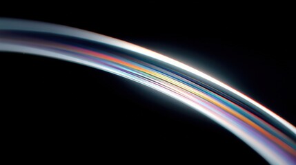 Abstract iridescent arc against black backdrop, showing multiple spectral colors and light refraction, ideal for backgrounds