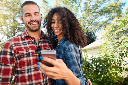 Happy, couple and selfie at backyard, online and memory for social media post, bonding and together. Outdoor, man and woman with smile for picture, photography and interracial marriage, love or home