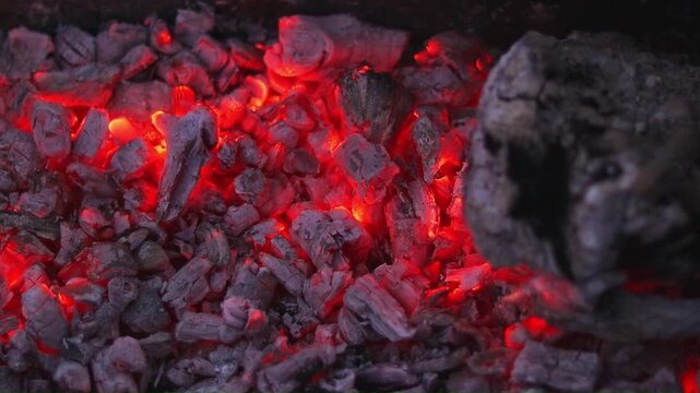 The fires in the campfire are burning and warming us with their warmth. Here and there a large fire is still burning, especially on a wooden figure. The hot embers are flickering.