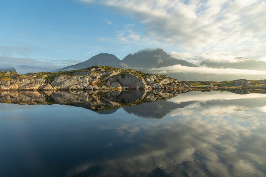 Majestic Norwegian fiord reflecting serene landscapes
