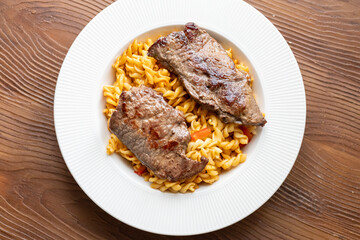 Close-Up of Italian Pasta with Tomato Sauce and Beef Steak