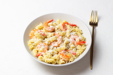 Pasta in a creamy sauce with shrimp and cheese. Italian cuisine.