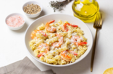 Pasta in a creamy sauce with shrimp and cheese. Italian cuisine.