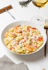 Pasta in a creamy sauce with shrimp and cheese. Italian cuisine.
