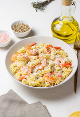 Pasta in a creamy sauce with shrimp and cheese. Italian cuisine.