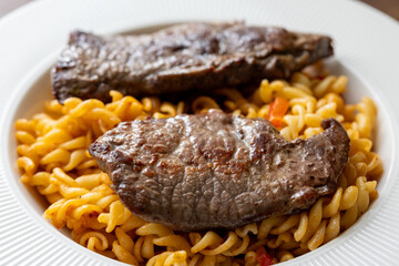 Close-Up of Italian Pasta with Tomato Sauce and Beef Steak