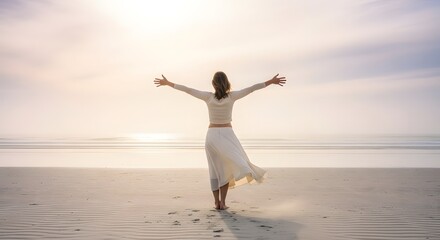 Fototapeta premium Woman with arms outstretched embracing the sunrise on a serene beach.