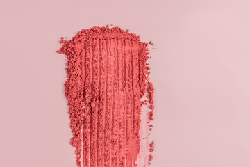 Powdery blush spread on a soft pink surface