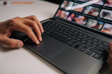 Cropped shot of male hand navigating touchpad on laptop keyboard during online meeting, emphasizing essence of remote work and modern digital communication. Concept of remote workplace.
