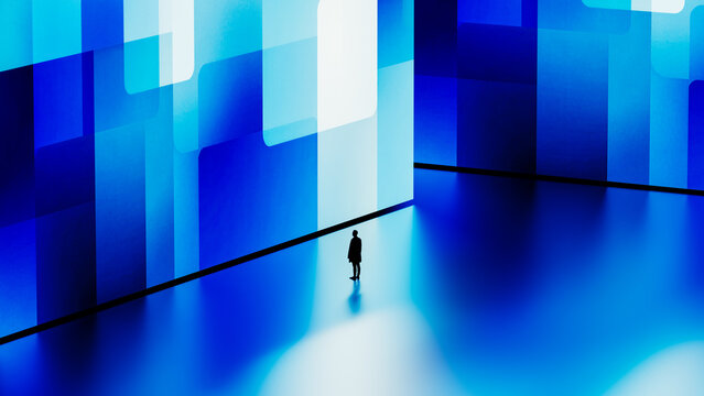 Silhouette of a man against a digital blue geometric background