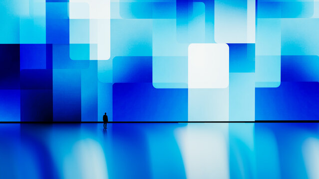 Silhouette of a man against a digital blue geometric background