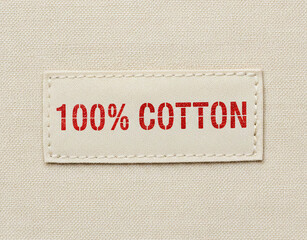 100 Cotton Fabric Label with Red Text on Textile Background