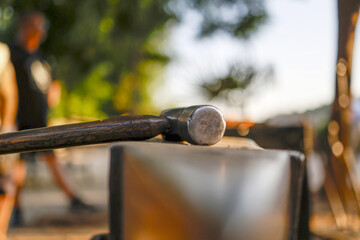 Medieval sword forge with focus on hammer and anvil